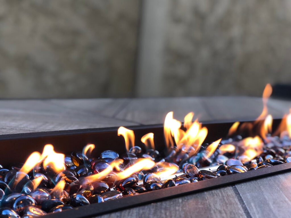 A lit firepit awaits a group of weary adventurers to put their feet up and relax by the fire