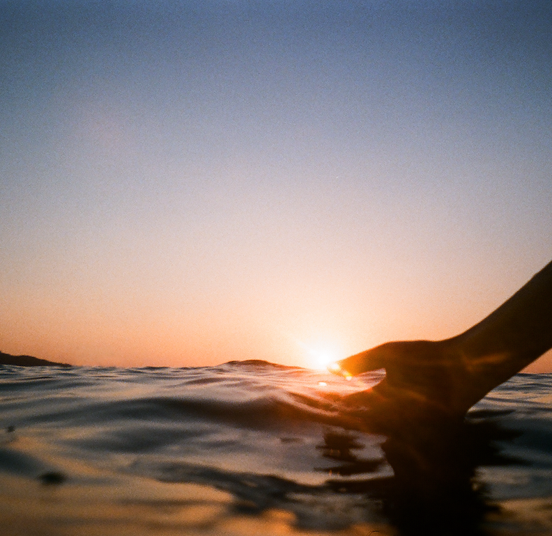 A-setting-sun-turns-the-sky-vibrant-orange-over-the-glistening-waves-of-Estero-Bay