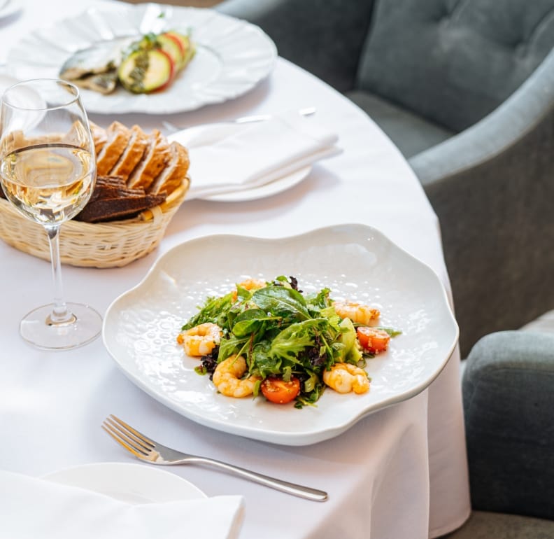 With napkins folded and tablecloth pressed, an empty table awaits its hungry guests at the signature restaurant located in The Ritz-Carlton Residences, Estero Bay